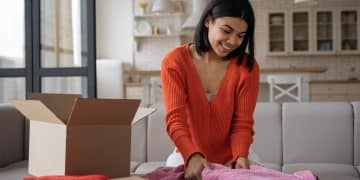 smiling-african-american-woman-packing-volunteering-box-home-donation-concept