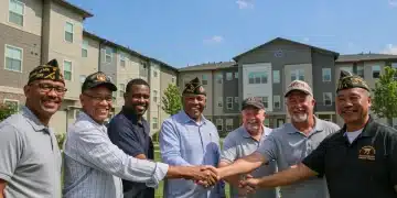 Veterans smiling in front of new housing, symbolizing new assistance programs.